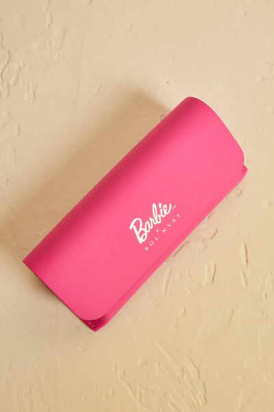 Pink Barbie sunglasses case with yellow background -top view.