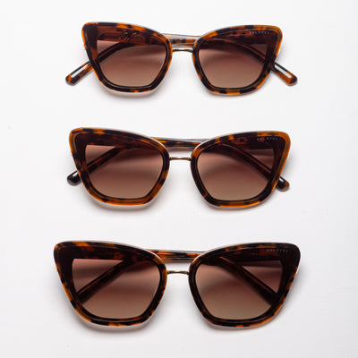 Three pairs of tortoise cat-eye sunglasses with gradient brown lenses, aligned vertically on a white background.